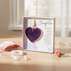 2 of 4:Stained purple glass heart gift for daughter on a table in front of a window.