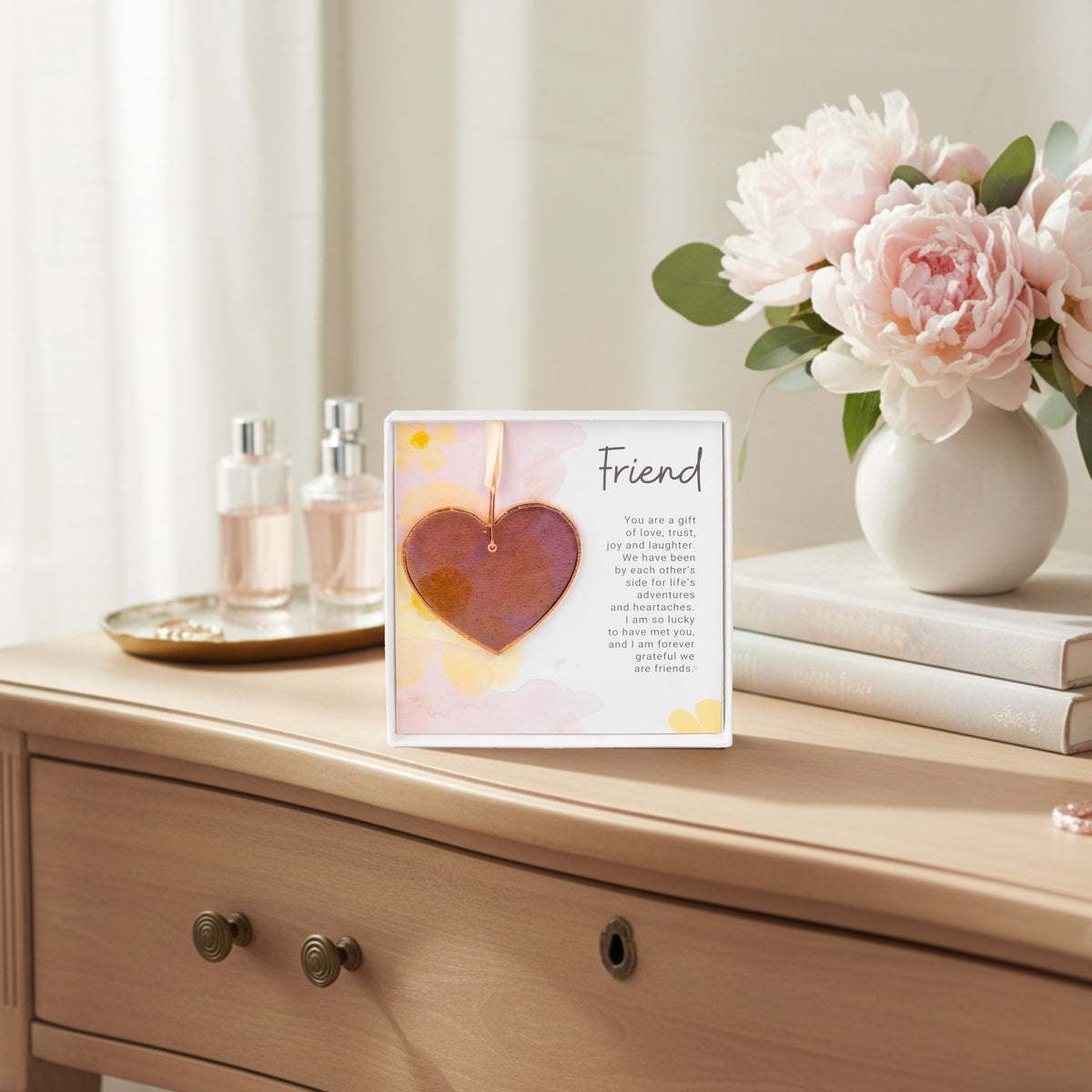 Pink rose mauve glass heart gift for friend on a woman's dresser.