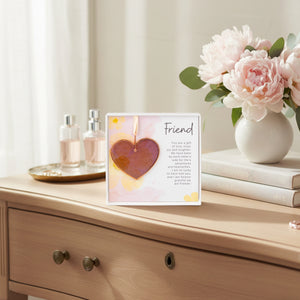 3 of 6:Pink rose mauve glass heart gift for friend on a woman's dresser.