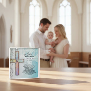 5 of 5:Parents holding baby with the Dedication cross displayed in front of them.