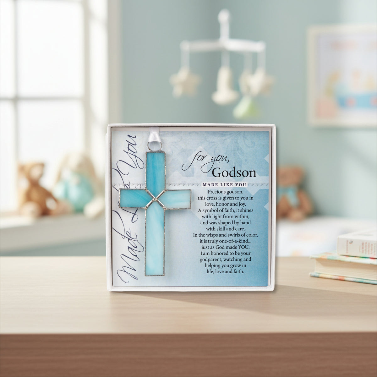 "For You, Godson" gift displayed on a shelf in a baby boy's nursery.