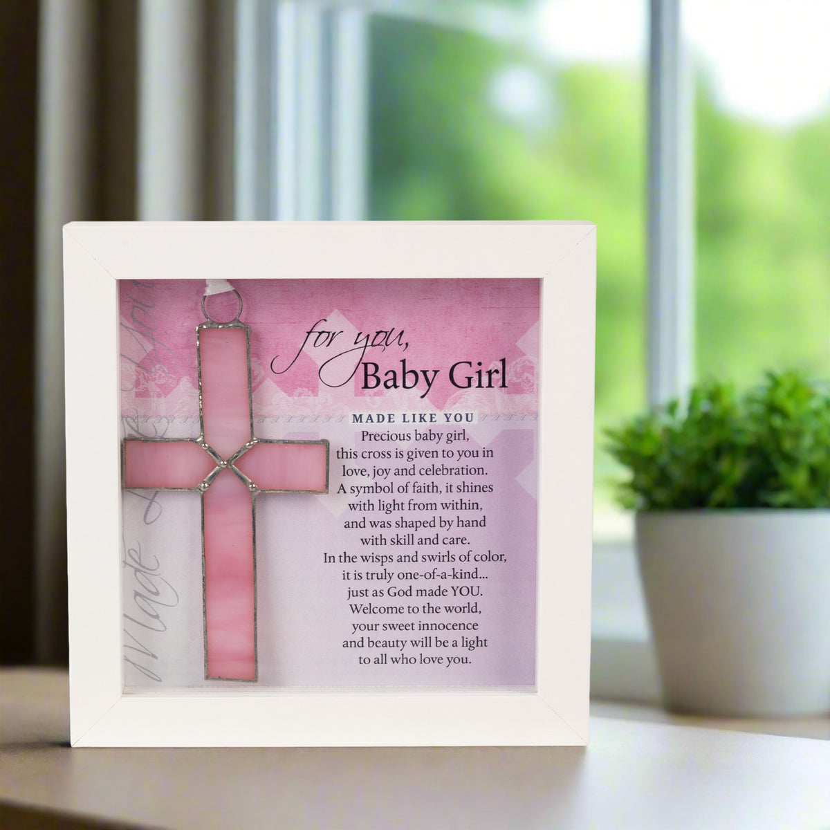 Baby Girl gift displayed on a table in front of a window.