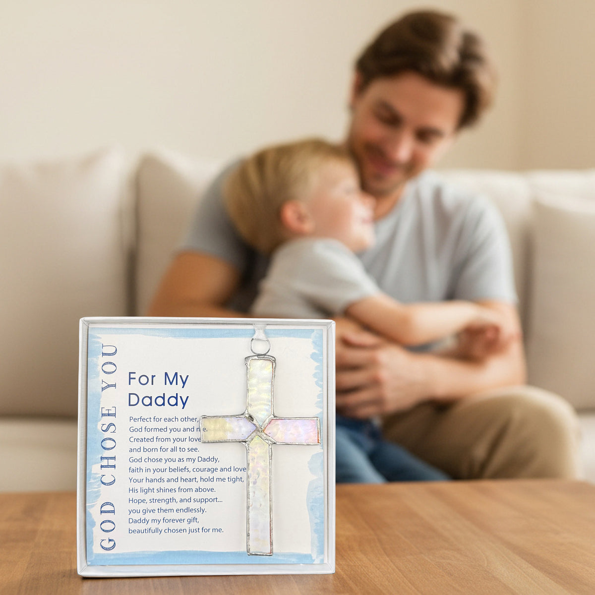 "For My Daddy" stained glass cross gift for Dad on a table in front of a father and his child snuggling.