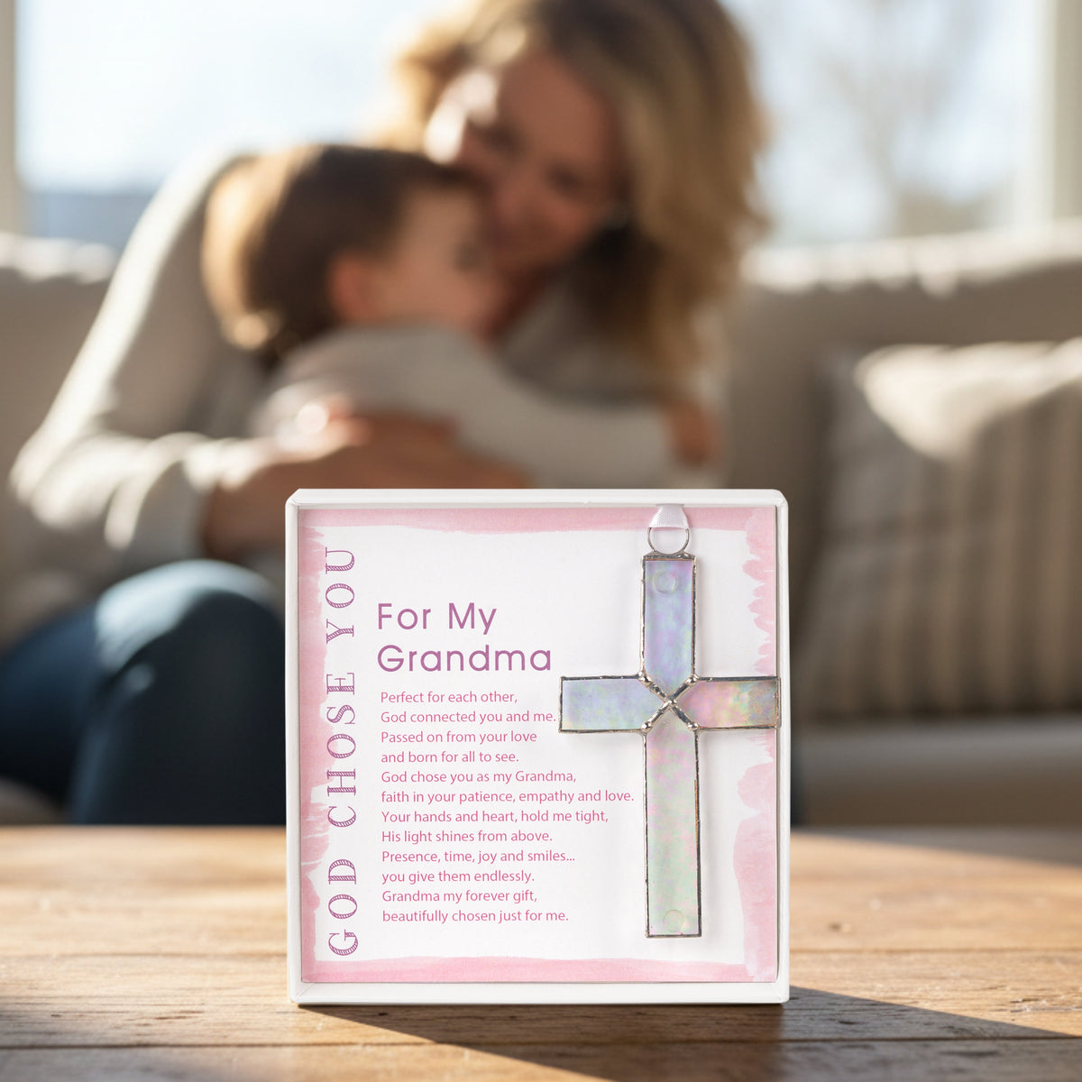 "For My Grandma" gift on a table with a grandma snuggling her grandchild in the background.