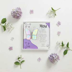 3 of 4:Butterfly gift for mom surrounded by flowers