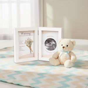 3 of 5:Ultrasound Frame sitting on a child's blanket next to a stuffed teddy bear.