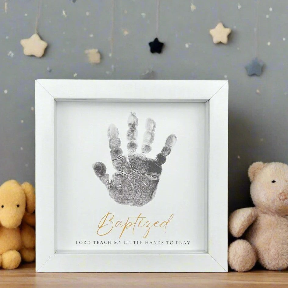 5x5 white frame with "Baptized" Sentiment with space for a child's handprint.