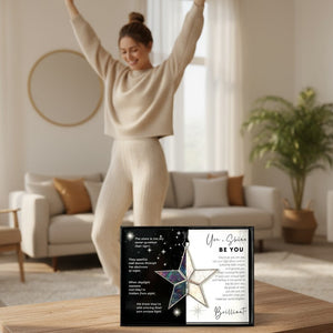3 of 7:The Be You star on a table in front of a woman dancing.