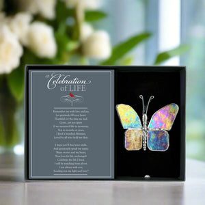 3 of 5:Clear iridescent butterfly in a gray box with a 'Celebration of Life' card.