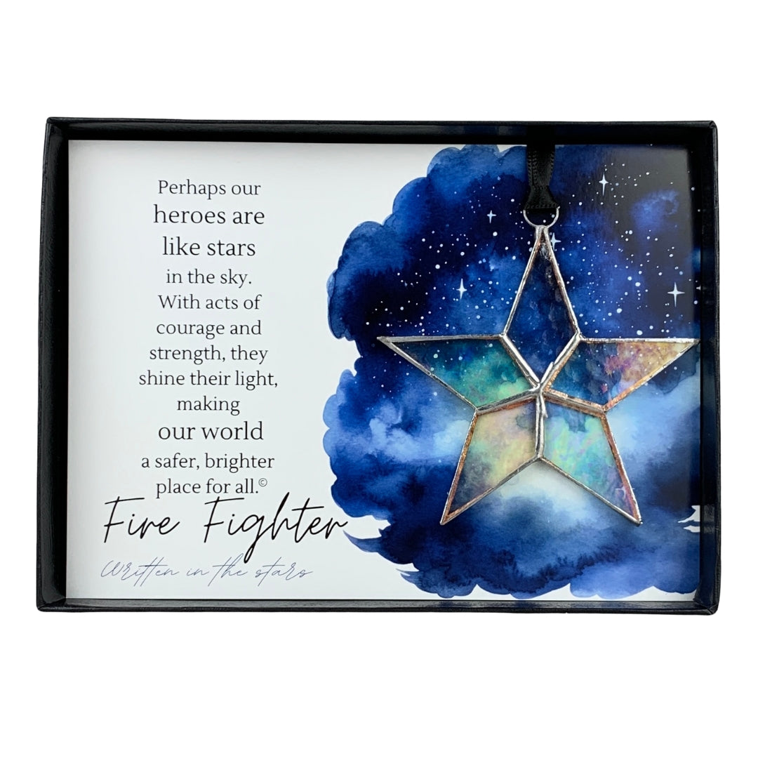 Handmade 4" clear iridescent stained-glass star with silver edging, packaged with "Fire Fighter" sentiment in black gift box with clear lid.