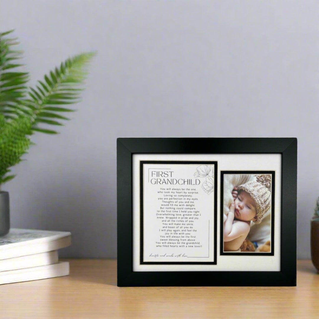 First Grandchild black frame on a table.
