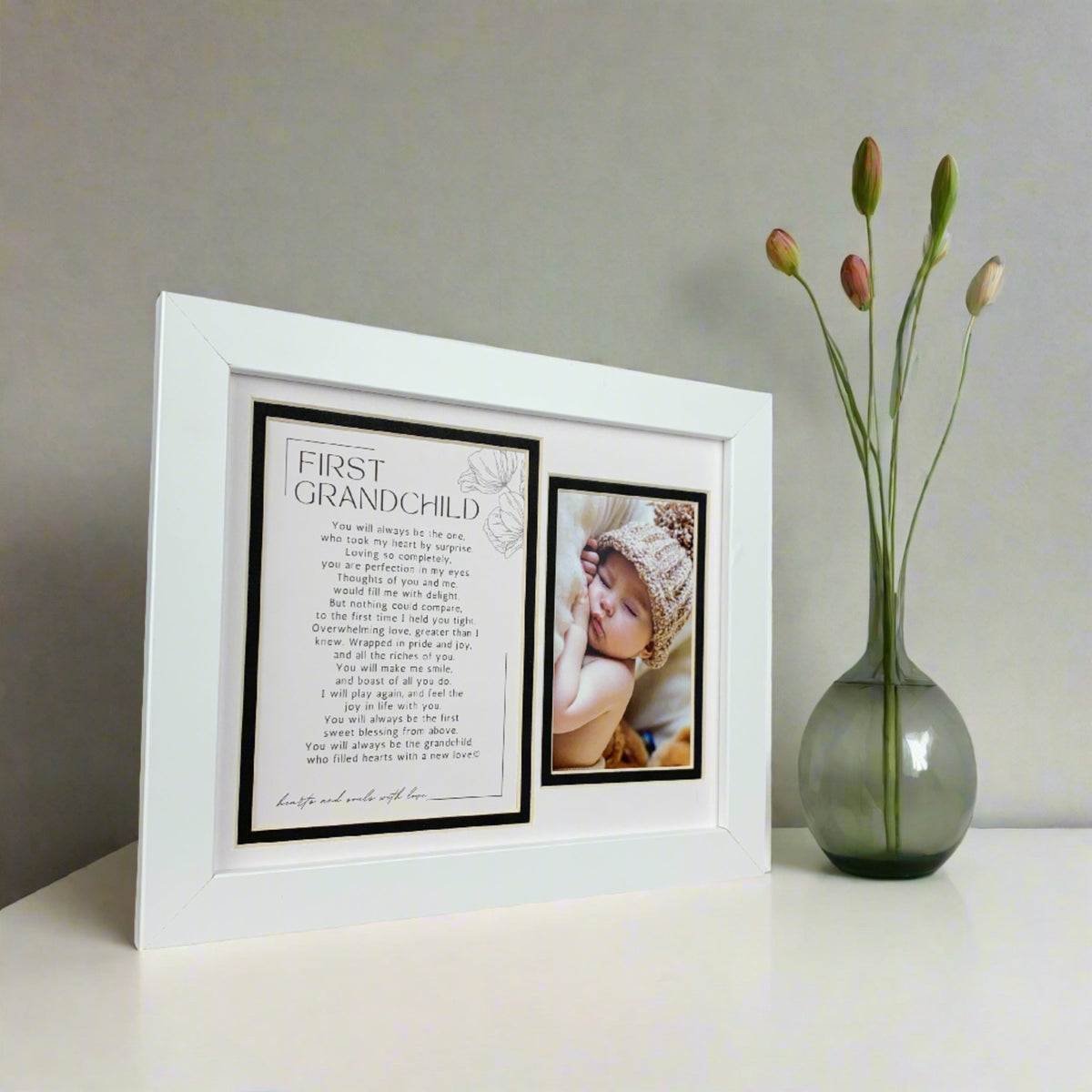 White First Grandchild frame on a table.
