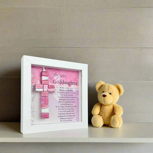 4 of 8:Framed Goddaughter cross on a shelf in a nursery.