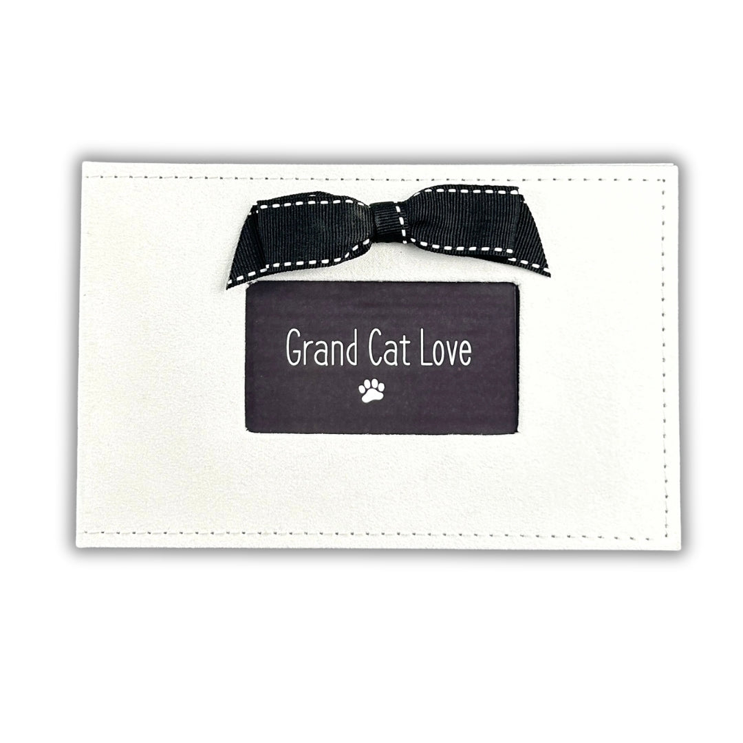 White photo album for photos of Grand Cat.