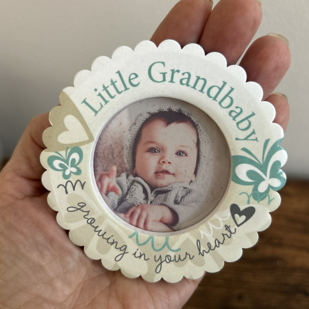 Grandbaby mini frame held in the palm of a hand.