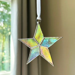 6 of 7:Clear iridescent star with white ribbon for hanging.