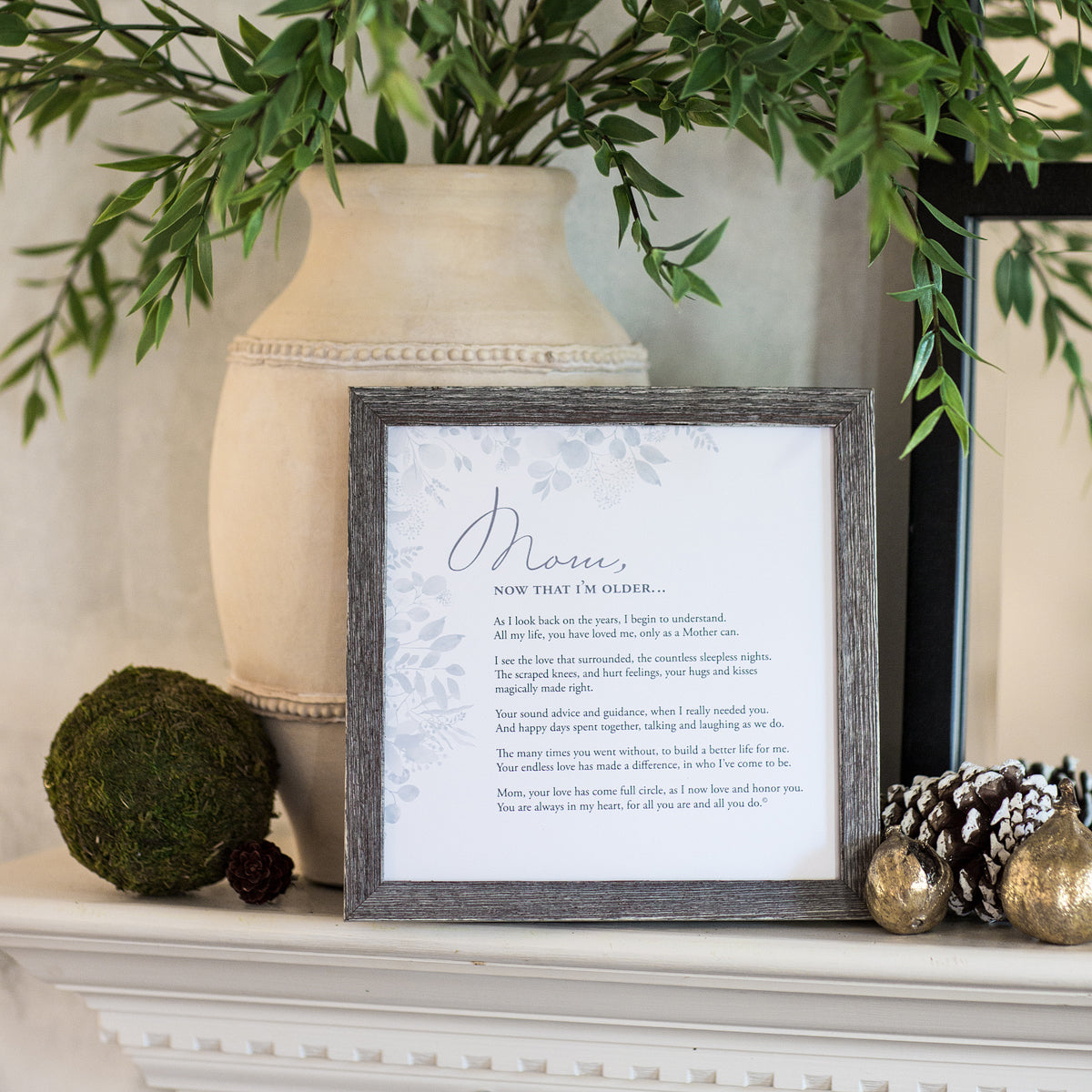 "Mom, Now that I'm Older" poem in 8x8 wood frame on a fireplace mantle.