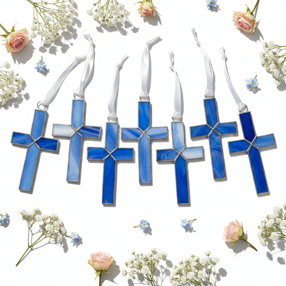 Variety of the blue stained glass crosses showing the unique colors of each piece.