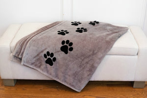 7 of 8:A close up of the pawprints that run up the side of the blanket.