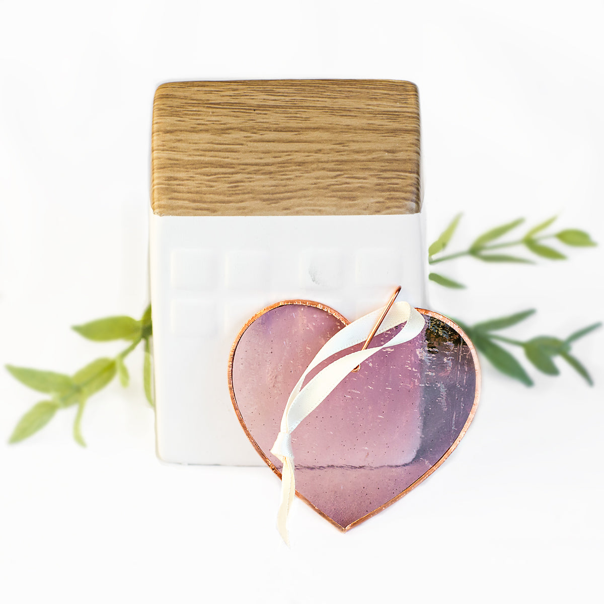 Pink glass heart with bubbles, ripples and texture inherent to handmade glass.