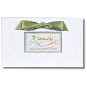1 of 8:White faux suede photo album with green satin bow and a window with Miracle sentiment artwork showing.