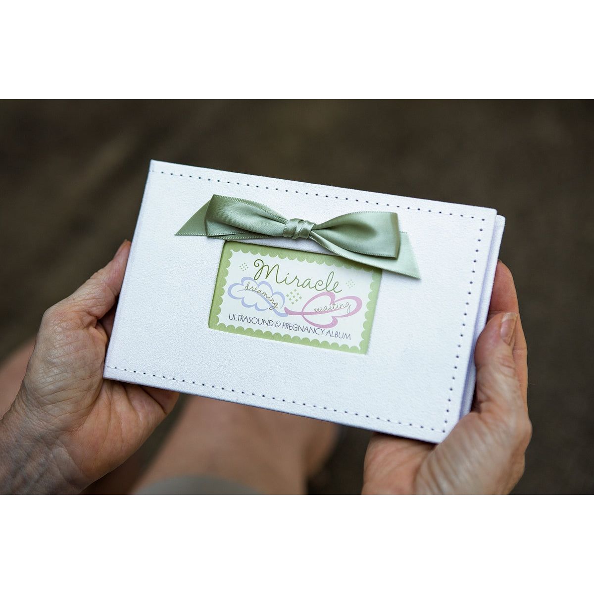Photo album being held in hands.