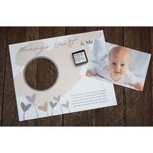 7 of 11:Artwork, stamp pad, and baby photo ready to be assembled.