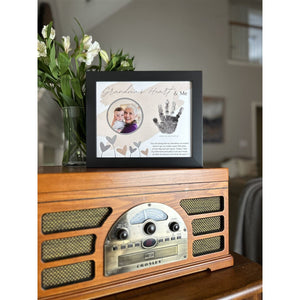 3 of 8:Grandma's Heart & Me frame in a living room.