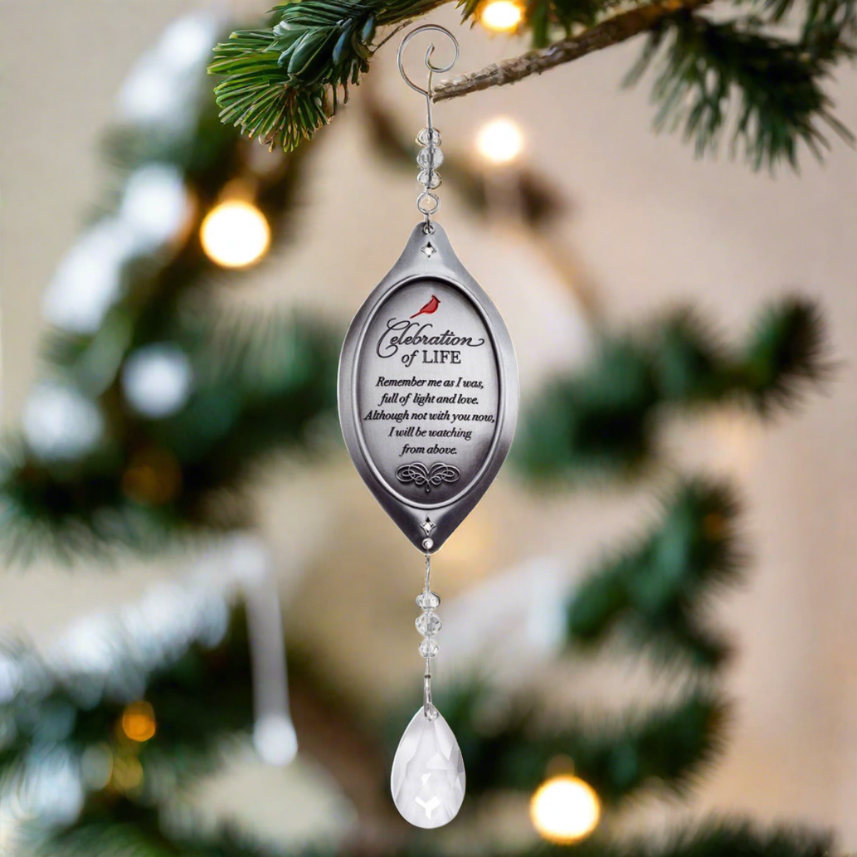 Celebration of Life ornament hanging from a Christmas tree.