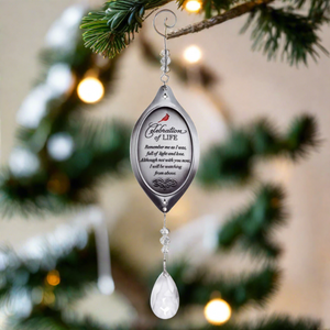 6 of 6:Celebration of Life ornament hanging from a Christmas tree.