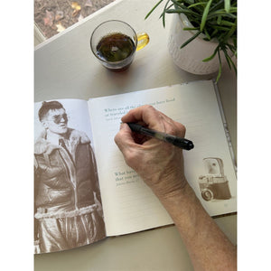 4 of 8:A grandmother answering one of the questions in the memory book.