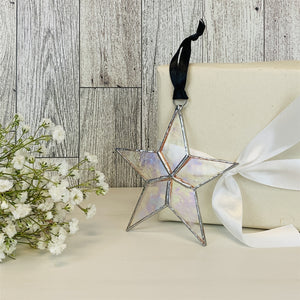 3 of 7:Clear iridescent star with black satin ribbon for hanging.