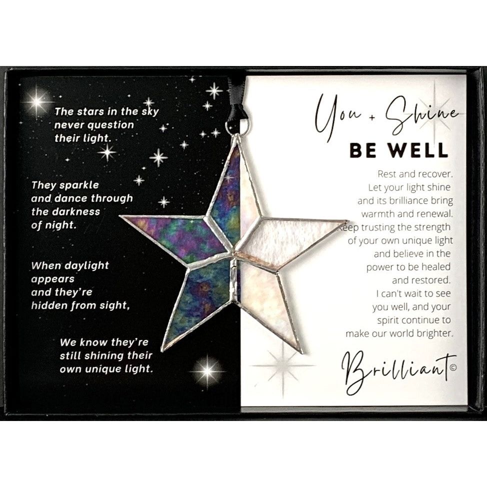 Handmade 4&quot; clear iridescent stained glass star with silver edging, packaged with &quot;You + Shines Be Well&quot; sentiment in black gift box with clear lid.