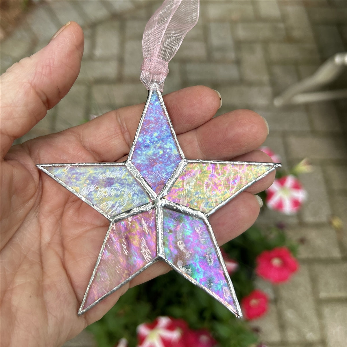 Iridescent star being held in a hand.