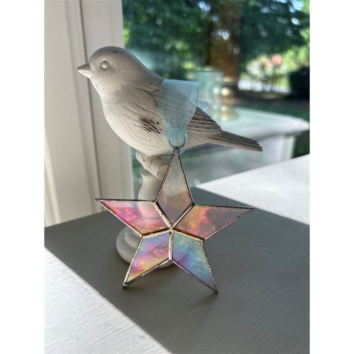 Star leaning against an object on a desk.