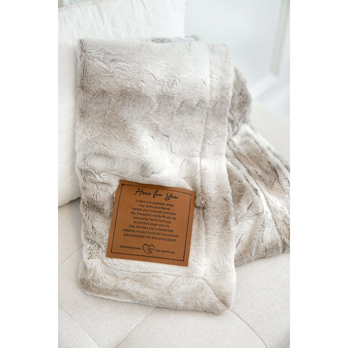 Here for You blanket folded and showing the color variation and texture of the faux fur.