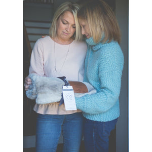 2 of 9:Two women exchanging the sympathy blanket gift.
