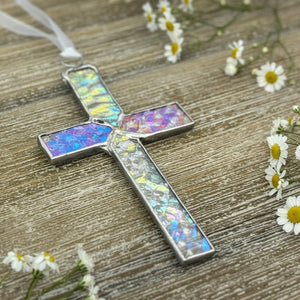 2 of 4:Clear iridescent stained glass cross with white satin ribbon for hanging.
