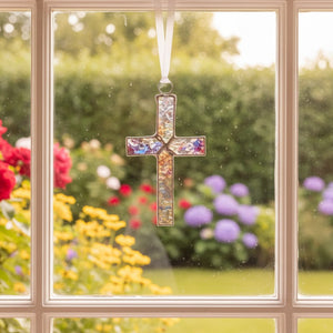 4 of 4:Clear iridescent stained glass cross hanging in a window.