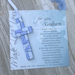 2 of 7:Blue Mosaic cross with shades of blue and white glass lying on the For You, Godson sentiment artwork.