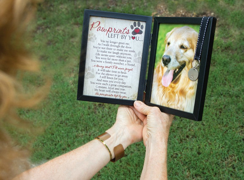 Pawprints Left by You Frame being held in hands.