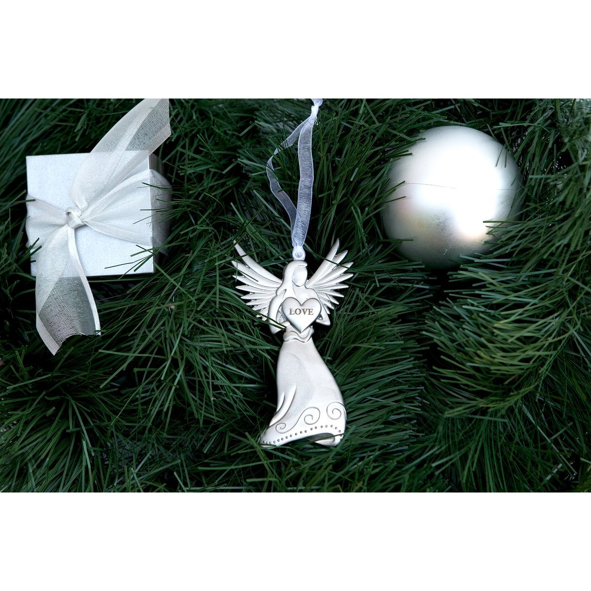 Silver toned metal angel holding a heart with the word "Love" in the center.
