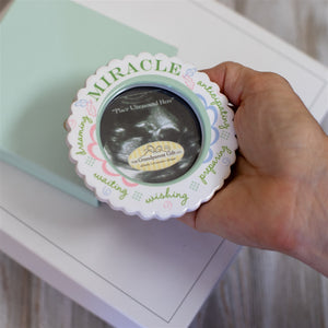 4 of 5:Miracle ornament being held in the palm of a hand.