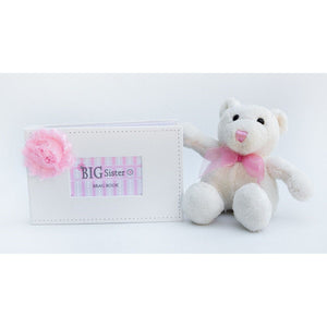 3 of 4:Big Sister Brag Book in setting with child's toy.