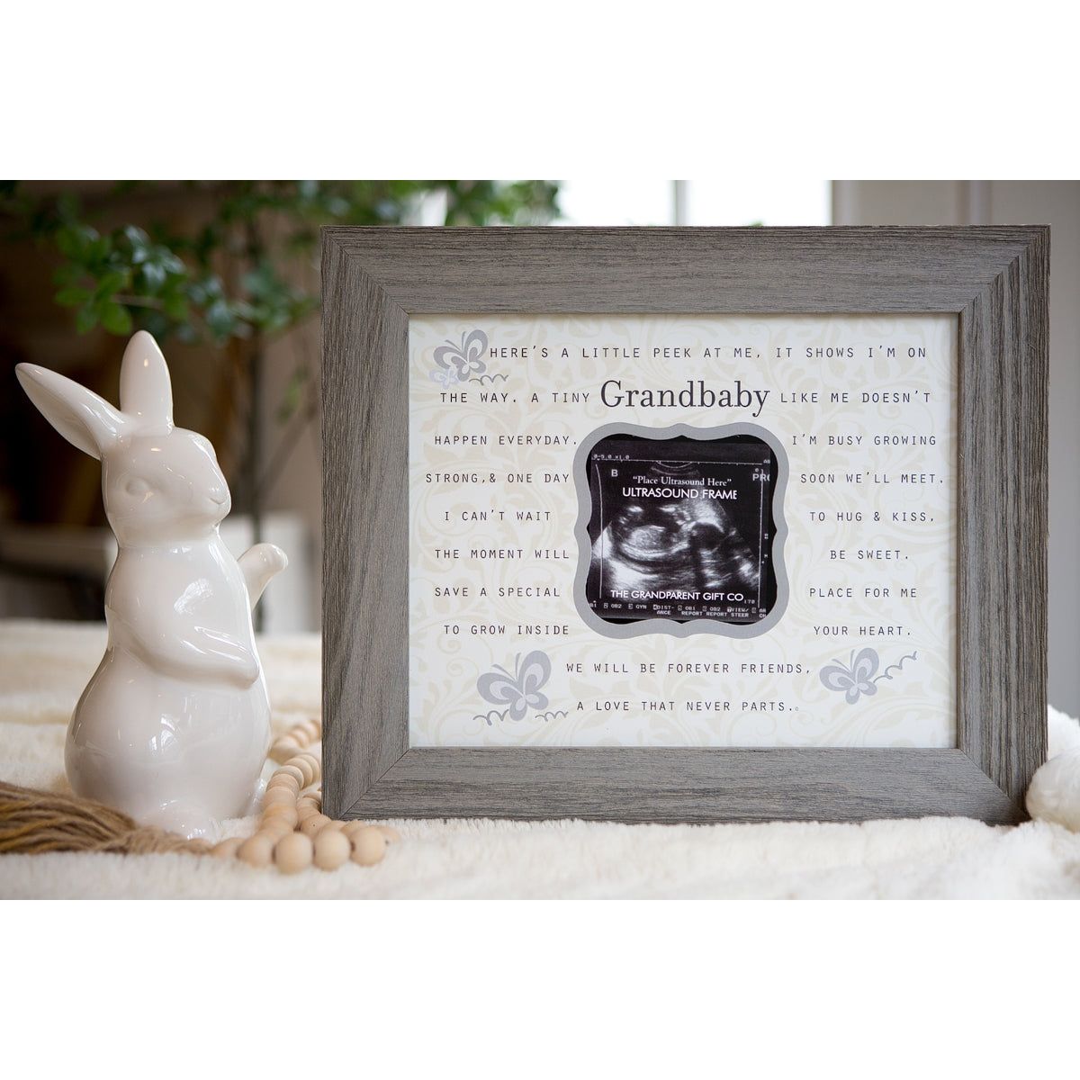 8x10 distressed gray real wood frame. Artwork with "Grandbaby" poem. Artwork has a cut out for an ultrasound.