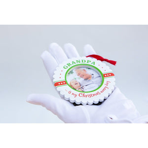 2 of 5:Grandpa Christmas ornament being held in a hand.