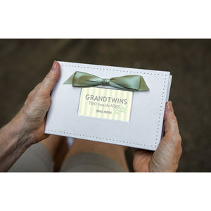 2 of 6:Grand Twins brag book being held in hands.