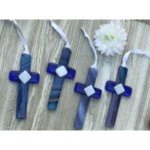 3 of 5:An assortment of blue glass crosses each unique.