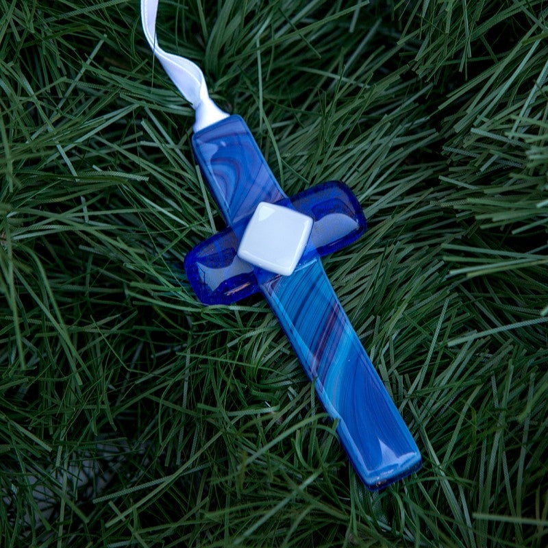 Blue glass cross with white satin ribbon for hanging.