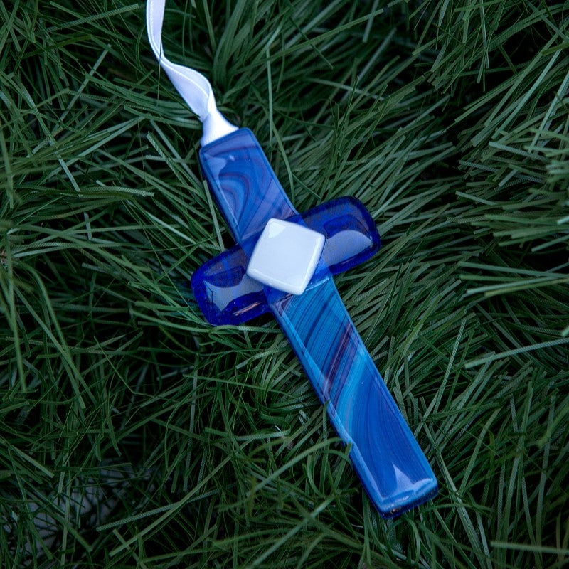 Blue glass cross with white satin ribbon for hanging.
